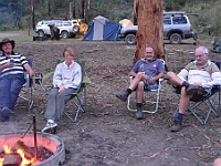 Colin, Karen, Darren, and Peter relax around the campfire at Little O'Tooles campground